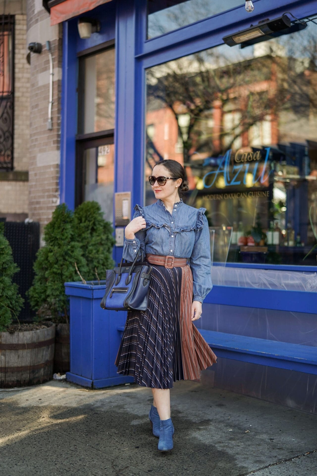 Anthropologie Pleated Skirt Veronica Beard Denim Shirt Coclico Booties Celine Luggage Bag Outfit by Modnitsa Styling