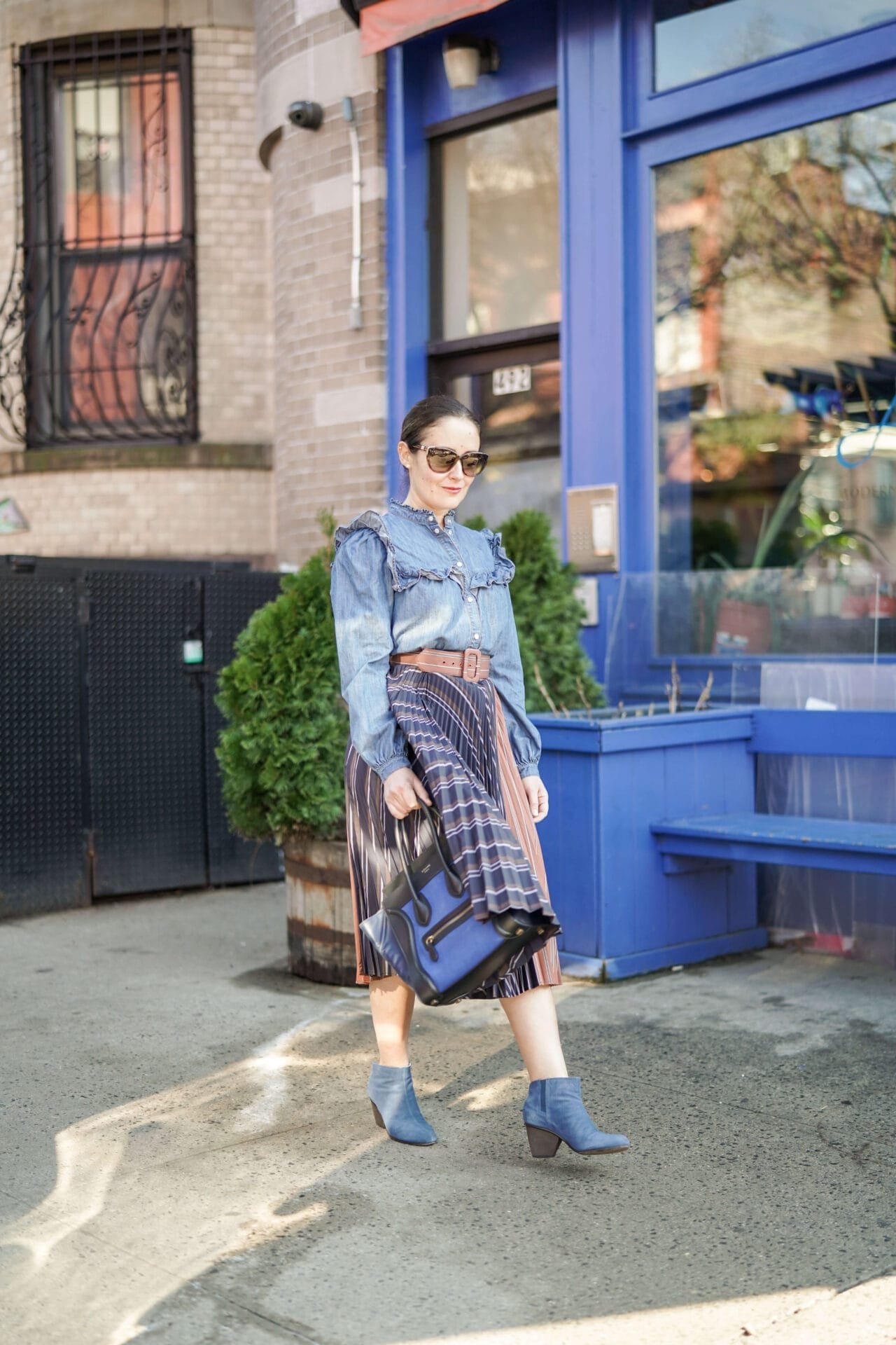 Anthropologie Pleated Skirt Veronica Beard Denim Shirt Coclico Booties Celine Luggage Bag Outfit by Modnitsa Styling